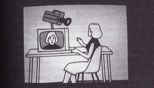 Simple illustration of a Love Tapes booth: A person sits at a table facing a monitor, atop which a large camera is positioned to point at the person.